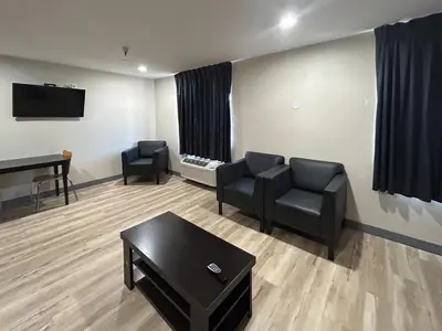 a waiting room with two chairs and a table at Studio 6 Suites Cameron Park, CA Folsom in Cameron Park