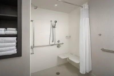 a white bathroom with a shower and a toilet at Residence Inn by Marriott Modesto North in Modesto