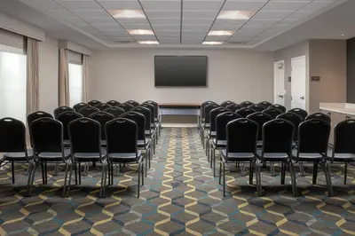 a conference room with chairs and a screen at Residence Inn by Marriott Modesto North in Modesto