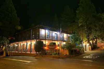 a building with lights on it at night at The Groveland Hotel in Groveland