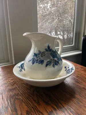 a blue and white vase on a plate on a table at The Groveland Hotel in Groveland
