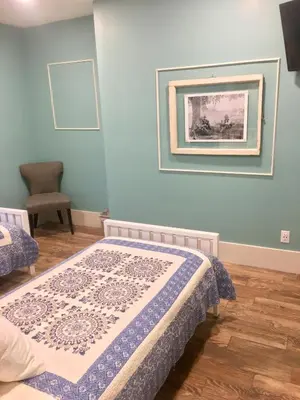 a bedroom with a bed and a picture on the wall at The Groveland Hotel in Groveland