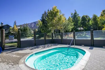 a small swimming pool in the middle of a backyard at Snowcreek 887 Condo in Mammoth Lakes