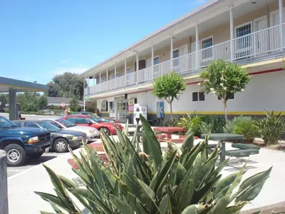 a parking lot in front of a building at Garlic Farm Inn in Gilroy