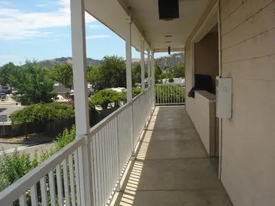 a balcony of a building with a view of a street at Garlic Farm Inn in Gilroy