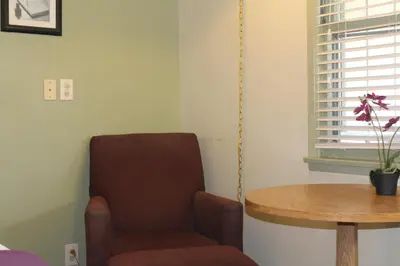 a living room with a chair and a table at El Rancho Motel in Bishop