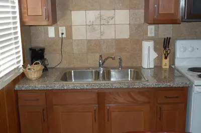 a kitchen with a sink and a counter top at El Rancho Motel in Bishop