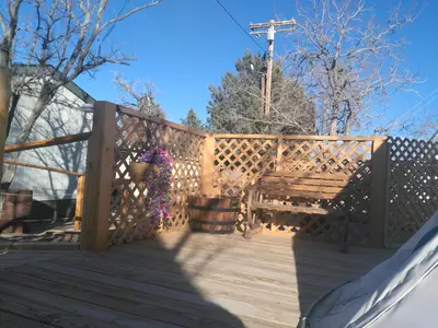 a wooden fence with a bench on a deck at Olancha RV Park and Motel in Olancha