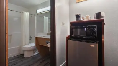 a bathroom with a refrigerator with a microwave on it at Sonora Aladdin Motor Inn in Sonora