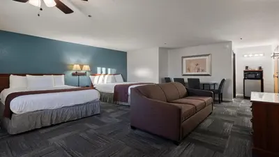 a hotel room with two beds and a couch at Sonora Aladdin Motor Inn in Sonora
