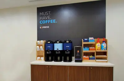a counter with bottles of coffee on it at Holiday Inn Express & Suites - Tulare by IHG in Tulare
