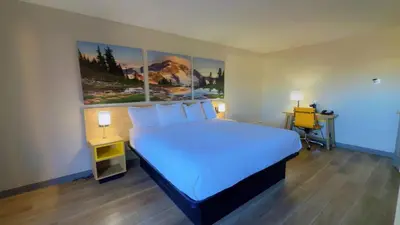 a bedroom with a large bed and a desk at Days Inn by Wyndham Reno in Reno