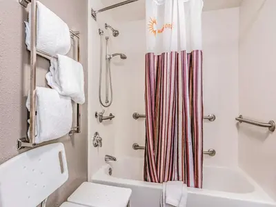 a bathroom with a white toilet and a shower at La Quinta Inn by Wyndham Fresno Yosemite in Fresno