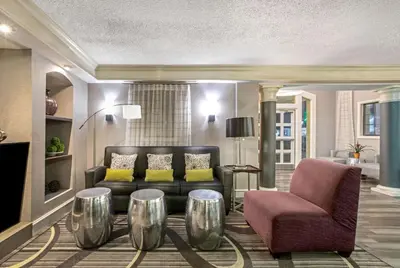 a living room with a couch and a chair at La Quinta Inn by Wyndham Fresno Yosemite in Fresno