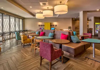 a restaurant with tables and chairs and windows at Home2 Suites By Hilton Reno in Reno