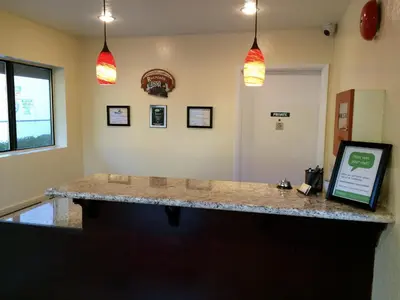 a bar in a room with two pendant lights at Jamestown Railtown Motel in Jamestown
