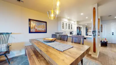a kitchen and dining room with a wooden table at Bridges #209 Condo in Mammoth Lakes
