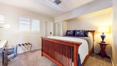 a bedroom with a bed and a desk and a window at Bridges #209 Condo in Mammoth Lakes