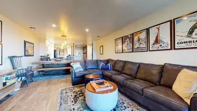 a living room with a brown leather couch and a table at Bridges #209 Condo in Mammoth Lakes