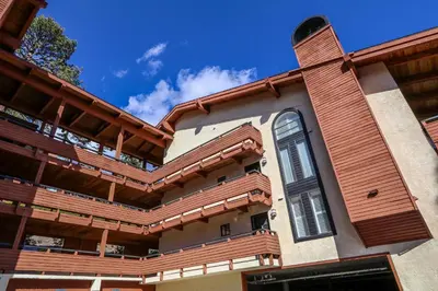 a house with a wooden deck on the side of it at Bridges #209 Condo in Mammoth Lakes