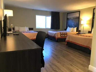 a hotel room with two beds and a desk at Hotel Elevation in South Lake Tahoe