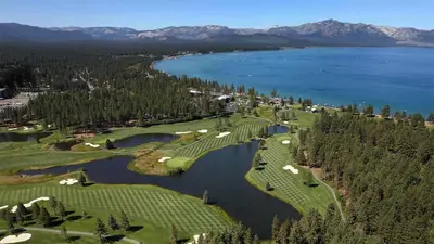 an aerial view of a golf course with a lake at Hotel Elevation in South Lake Tahoe
