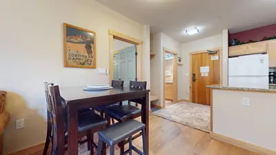 a kitchen and dining room with a table and chairs at Sunstone #126 Condo in Mammoth Lakes