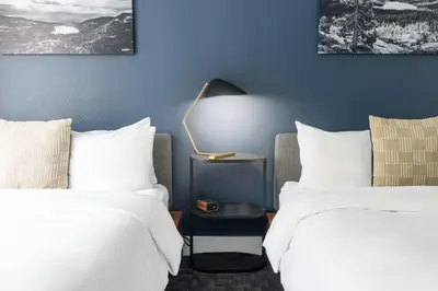 a hotel room with two beds and a lamp at Gravity Haus Truckee-Tahoe in Truckee