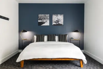 a bedroom with a large white bed with two lamps at Gravity Haus Truckee-Tahoe in Truckee