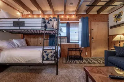 a bedroom with two bunk beds and a couch at Mother Nature's Inn in Tahoe City