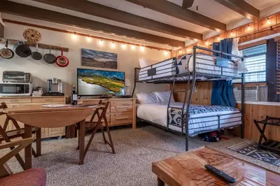 a bedroom with a bunk bed and a desk at Mother Nature's Inn in Tahoe City