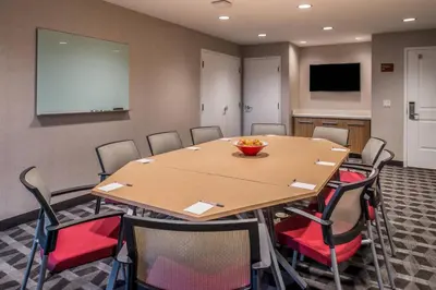 a conference room with a wooden table and chairs at TownePlace Suites by Marriott Merced in Merced
