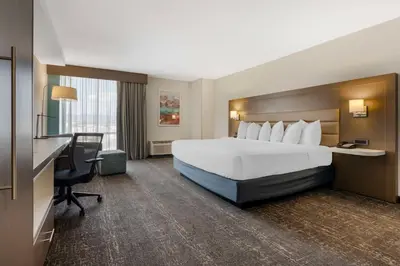 a hotel room with a bed and a desk and a computer at Best Western Plus Sparks-Reno Hotel in Reno