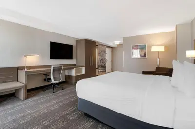 a hotel room with a large bed and a desk at Best Western Plus Sparks-Reno Hotel in Reno