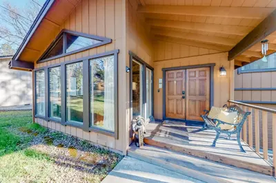 a front porch of a home with a glass door at Creekside Cabin in Groveland