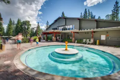a pool with a fountain in front of a house at Silver Star Retreat in Ponderosa Fairway Estates