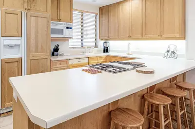 a kitchen with a white counter top and wooden cabinets at Silver Star Retreat in Ponderosa Fairway Estates