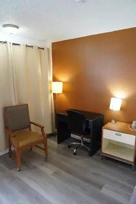 a room with a desk and a chair and a computer at Super 8 by Wyndham Fernley in Fernley