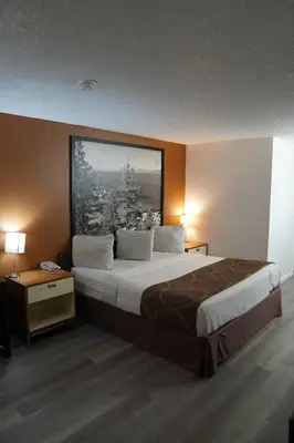 a large bed in a hotel room with two lamps at Super 8 by Wyndham Fernley in Fernley