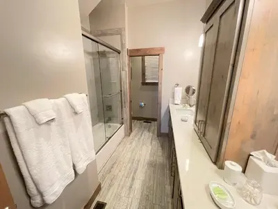 a white bathroom with a shower and a sink at Saint Bernard - Luxurious Upscale Comfy Mountain Retreat Hot Tub Gas BBQ with Level 2 EV Connection in Truckee