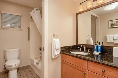 a bathroom with a toilet and a sink and a mirror at WorldMark Angels Camp in Angels Camp