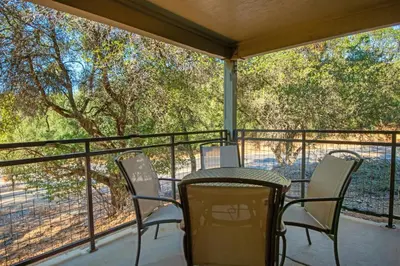 a table and chairs on a balcony with a view at WorldMark Angels Camp in Angels Camp