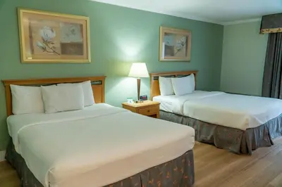 a hotel room with two beds in a room at Hotel Piccadilly in Fresno