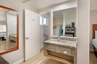a bathroom with a sink and a mirror at Best Western Inn in Merced