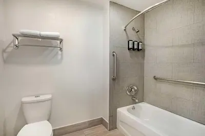 a bathroom with a toilet and a bath tub at Best Western Inn in Merced