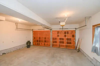 an empty garage with wooden doors in a room at Skyland Retreat - Max nighttime occupancy of 8 in Zephyr Cove