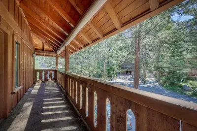 a balcony of a house with a view of the woods at Skyland Retreat - Max nighttime occupancy of 8 in Zephyr Cove
