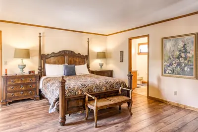 a bedroom with a bed and a chair at Skyland Retreat - Max nighttime occupancy of 8 in Zephyr Cove