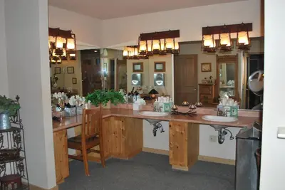 a bathroom with two sinks and a large mirror at Double Eagle Resort and Spa in June Lake