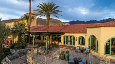 a house with palm trees in front of it at The Inn at Death Valley in Death Valley